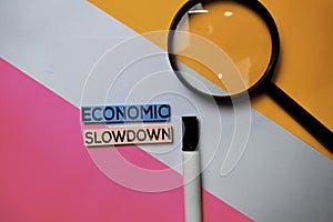 Economic Slowdown text on sticky notes with color office desk concept