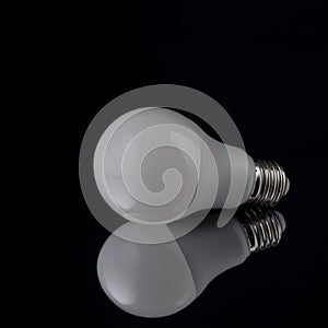 economical white light bulb on black background