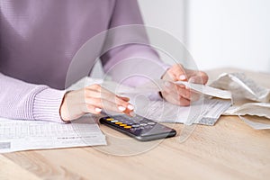 economical woman work on phone calculator at home pay bills taxes on gadget online, provident female calculate finances