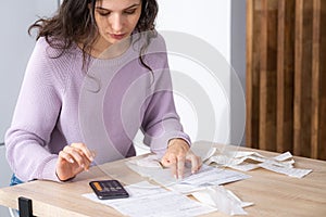 economical woman work on phone calculator at home pay bills taxes on gadget online, provident female calculate finances