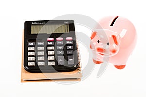 Economics and profit management. Economics and finance. Piggy bank pink pig and calculator. Exchange rates. Economics