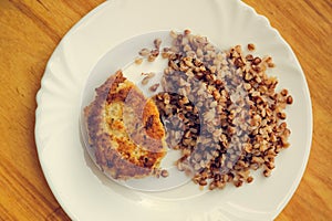 Economy food. rissole and buckwheat groats