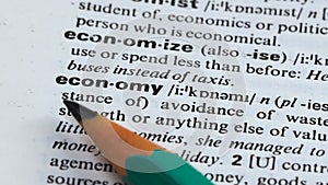 Economy word meaning in dictionary, avoiding of wasting resources, planning