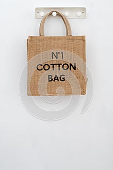 Ecoproduct. Brown cotton grocery bag on white wall background photo