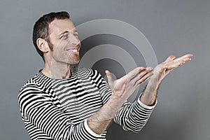 Ecstatic 40s man holding or presenting something