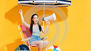 Ecstatic beautiful young Asian woman in cheering gesture