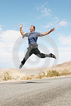 Ecstatic business man jumping in the air
