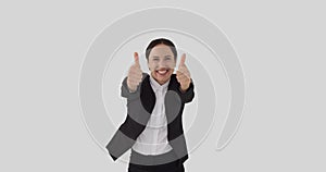 Ecstatic businessman giving thumbs up gesture