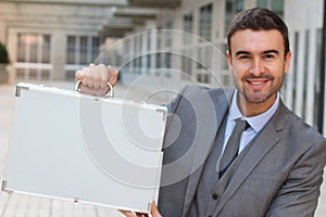 Ecstatic businessman holding a briefcase