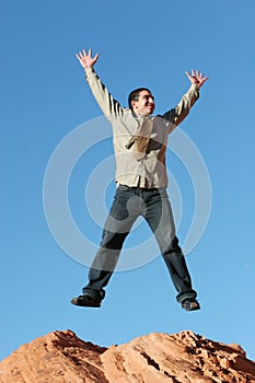 Ecstatic businessman jumping photo