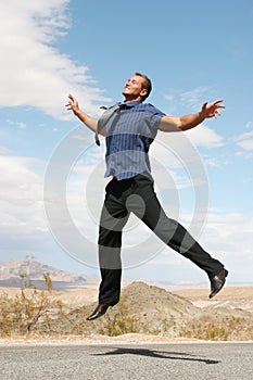 Ecstatic businessman jumping photo