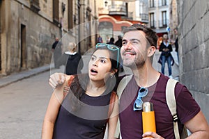 Ecstatic couple showing surprise during a vacation