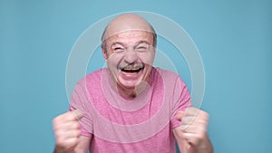 Ecstatic emotional male fan cheering for favorite sport team