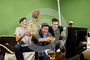 Ecstatic family, father and sons cheering for touchdown