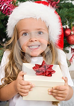 Ecstatic happy girl with christmas present photo