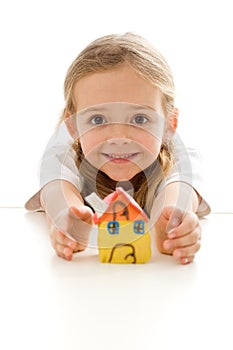 Ecstatic little girl with her clay house photo