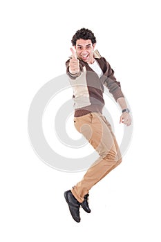 Ecstatic man showing thumbs up jumping of joy and excitement