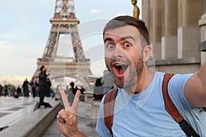 Ecstatic man taking a selfie in the Eiffel Tower, Paris