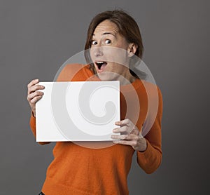 Ecstatic middle aged woman showing exciting copy space text