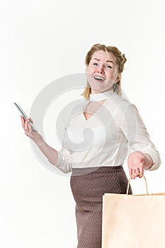 Ecstatic shopaholic women holding cell phone and shopping bags with purchases. Black Friday concept