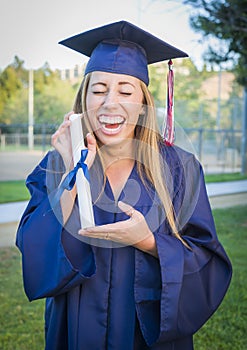 Ecstatic Teen Holding Diploma in Cap and Gown