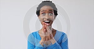 Ecstatic woman celebrating success over white background