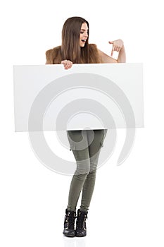 Ecstatic Woman Holding A Poster And Pointing At It