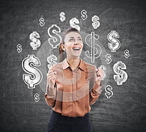 Ecstatic woman near a chalkboard with dollar signs