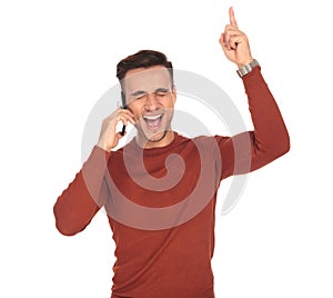 Ecstatic young man screaming of joy while talking on phone