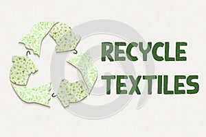 Ecycle textiles symbol made from old clothing fabric on recycled card, with text