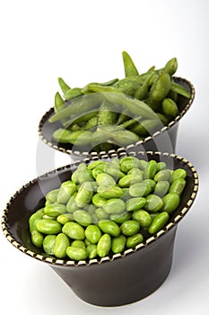 Edamame soy beans in a brown ceramic dish