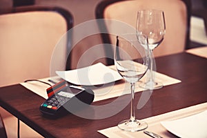 EDC machine or bankcard in reader on table in restaurant