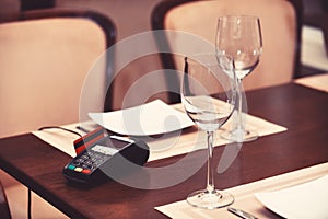 EDC machine or bankcard in reader on table in restaurant photo