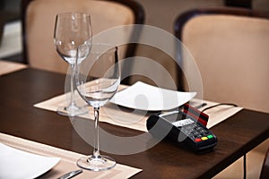 EDC machine or bankcard in reader on table in restaurant photo