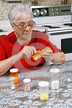 Ederly woman taking pills photo