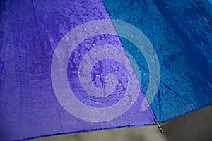 Edge of blue purple umbrella with metal spoke