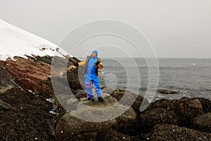 On the edge of earth, north of Russia, Arctic Ocean shore. Contrast of nature and man. Beautiful snowy view of sea shore with