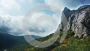 The edge of the land, a precipice, a very steep unapproachable cliff in the Crimea. The forest and thickets below. Drone