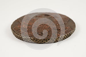 Edge of an old Russian copper coin of the 18th century on white