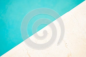 Edge of the pool and water. Exotic summer scene. Minimal vacation concept. Flat lay, top view. Copy space.