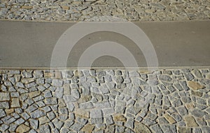 Edge of the river bank made of stone paving. asphalt road where you ride a bike path on a bike and inline skates on a paved promen