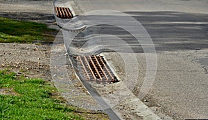 At the edge of the road is a concrete trough for collecting rainwater. for cars and cyclists to cross this drainage gutter with th