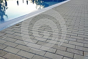 Edge Of Swimming Pool With Reflection And Concrete Paving