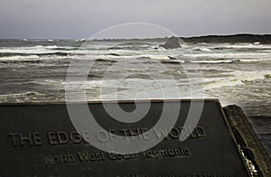The Edge of the World sign with rough ocean in background