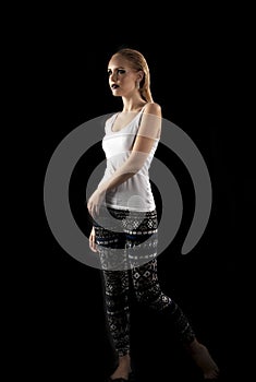 edgy woman posing in front of black background