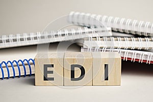 edi acronym on wood block cubes on wooden table over light blue gradient background, Frequently asked questions, Business customer