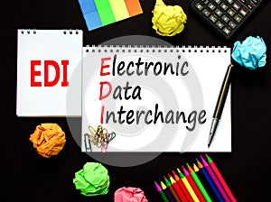 EDI electronic data interchange symbol. Concept words EDI electronic data interchange on white note on a beautiful black