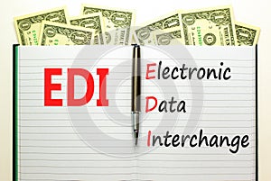 EDI electronic data interchange symbol. Concept words EDI electronic data interchange on white note. Beautiful dollar bills