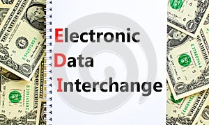 EDI electronic data interchange symbol. Concept words EDI electronic data interchange on white note. Beautiful dollar bills