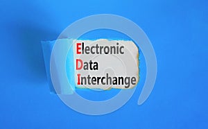 EDI electronic data interchange symbol. Concept words EDI electronic data interchange on white paper on a beautiful blue